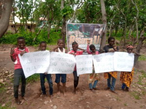 Pupils display cards during tree planting